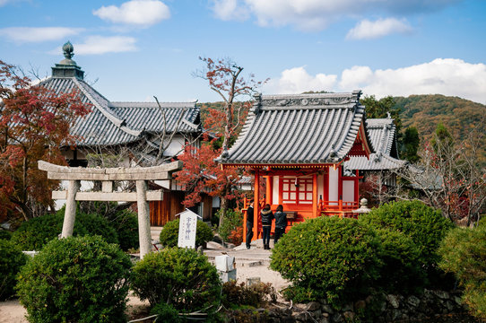 Local Japanese woman praying at Uka Shrine, Fugenin temple in Okayama