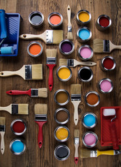 Metal tin cans with color paint and paintbrush