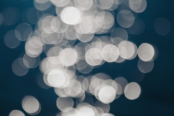 the concept of boating, relaxing at sea - splashes of blue water in the sea close-up. Colorful Bright Stage Lights in a Concert the blurred blue and white light spotlights. boce as background