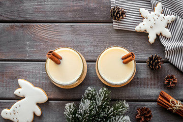 Eggnog - cute New Year composition with alcoholic drink on dark wooden background top view copy space