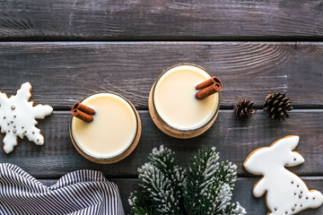 Eggnog - cute New Year composition with alcoholic drink on dark wooden background top view copy space
