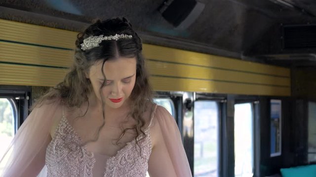 Young Brunette Bride Aboard A Train With Flowing Dress