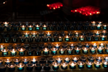 Group of candles lit in a church