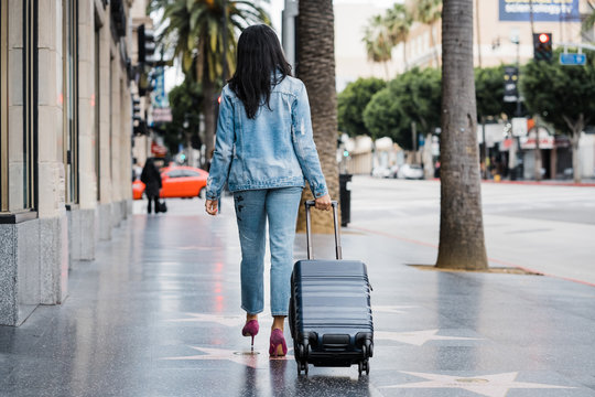 woman with luggage in Hollywood