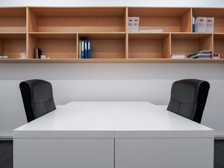 Small office interior with wooden shelving