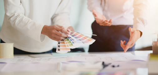 Cropped shot of young professional architect team working on their project together in modern office