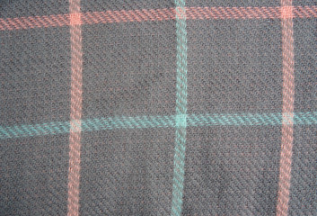 background of plaid wool blanket. Gray with pink and mint.