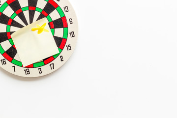 Choose business strategy concept. Dartboard with paper for text on white background top view mockup copy space