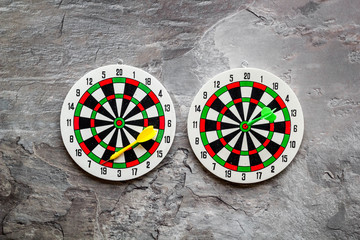 Accuracy of precision concept. Dartboard and arrows on grey background top view copy space