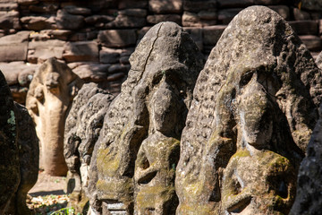 Fototapeta na wymiar The antique sandstone statue carving Khmer art at Phimai castle historical park.
