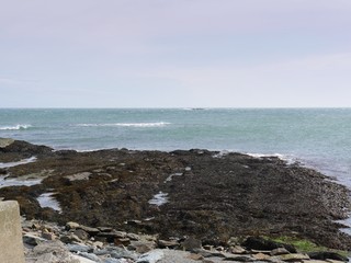 Rocky shoreline seen from the coastal road of Narragansett, Rhode Island.