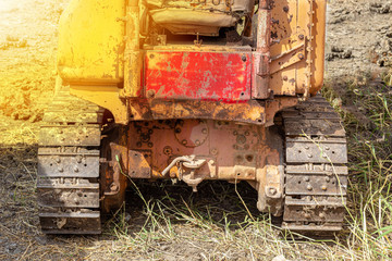 Fototapeta na wymiar .Old yellow-tone tracked tractors, heavy-duty
