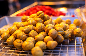 Crispy fish balls in a hot pan, sauce eaten sweet and sold in the general market