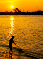 The fisherman cast a net the sea in the morning, at sunrise, Songkhla Thailand