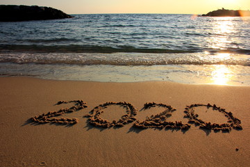 Fototapeta premium Happy New Year 2020 is coming concept on the sunset and tropical ocean beach lettering. 