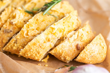 sliced bread sprinkled with cheese and herbs
