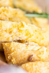 sliced bread sprinkled with cheese and herbs
