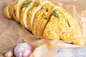sliced bread sprinkled with cheese and herbs