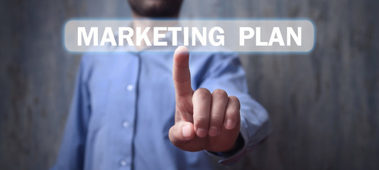 Man touching in Marketing Plan text in screen.
