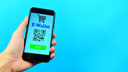Business man holding e wallet app on smartphone technology pay on blue background - Mobile payment online shopping concept