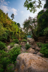 Fototapeta na wymiar take a boat to beautiful blue sky green forest mountains lake view at Khun Dan Prakarn Chon Dam waterfall, nakhon nayok, Thailand. an idea for backpacker hiking or camping on long weekend holiday