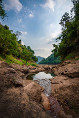 take a boat to beautiful blue sky green forest mountains lake view at Khun Dan Prakarn Chon Dam waterfall,  nakhon nayok, Thailand. an idea for backpacker hiking or camping on long weekend holiday