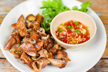 Roasted pork Chitterlings with chilli sauce spicy - entrails intestines part of pork asian thai food