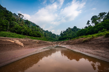 take a boat to beautiful blue sky green forest mountains lake view at Khun Dan Prakarn Chon Dam waterfall,  nakhon nayok, Thailand. an idea for backpacker hiking or camping on long weekend holiday