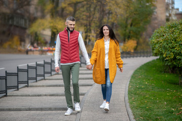 Nice happy couple holding their hands together