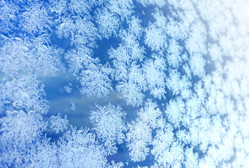 Ice flowers frozen blue window textured background