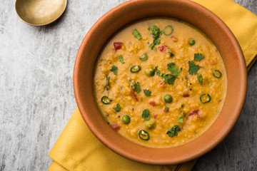 Vegetable masala oats khichadi served in a bowl. selective focus