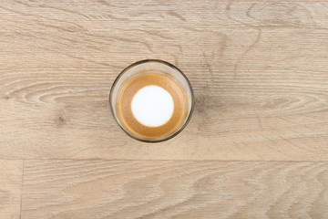 Macchiato Coffee Cup - Coffee in a black cup isolated on a wooden background - Cappuccino Latte Espresso   