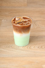 iced pistachio latte cup on a wooden background 