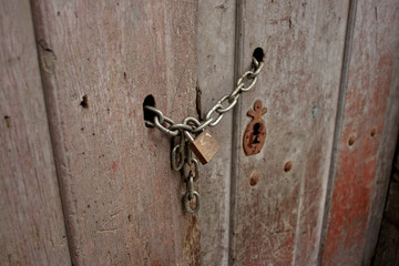 Old wooden door with padlock