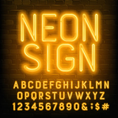 Neon Sign alphabet font. Yellow neon letters and numbers. Brick wall background. Stock vector typescript for your typography design.