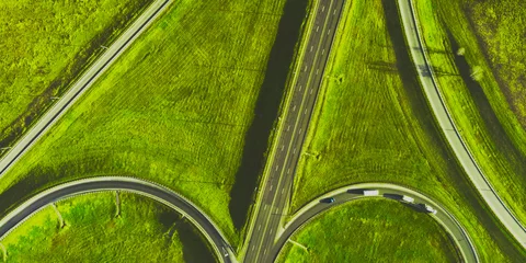 Plexiglas foto achterwand Drone view of morning empty country side road with beautiful green landscape around © Nataliya