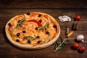 Tasty fresh hot pizza against a dark background. Pizza, food, vegetable, mushrooms.  It can be used as a background