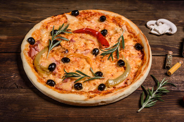 Tasty fresh hot pizza against a dark background. Pizza, food, vegetable, mushrooms.  It can be used as a background