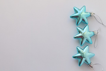 Shiny blue Christmas tree toy stars on white background.  Christmas Background. Selective focus