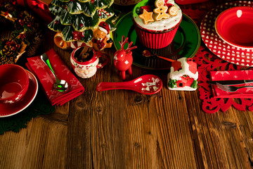 Christmas time. Christmas tableware and decorations. Red and brown colors. Rustic wooden background.