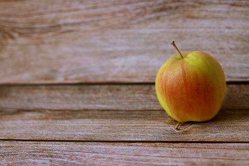 Fresh green red apple on wood background. Selective focus. Rustic style