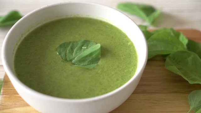 spinach soup bowl on wood background