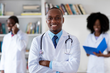 African american mature doctor with medical team