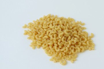 A pile of pasta horns on gray  background