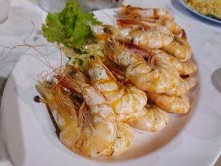 Top view of barbecued shrimp on white plate as a background in restaurant, Ready to serve or eat