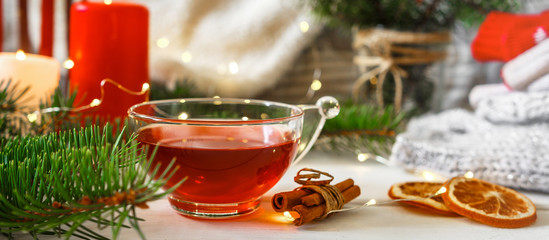 Cozy autumn winter home, Christmas eve. Cup tea, autumn garland on a wooden table near the bed with warm plaids. Autumn lifestyle lagom hygge.holiday and a weekend in the fall in winter on holidays.