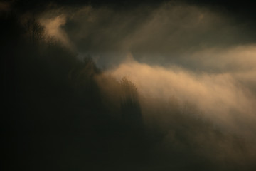 Alpine sea in the mountains. Dumesti a village from Romania cover in fog.