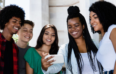 Hispanic and latin and afrian american young adult people watching clip