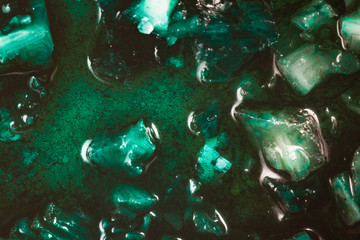macro close-up photo of oxidizing vivid green blue copper and sulfate salt in bright lit clear...