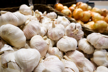 Organic garlic agriculture harvest herb near natural onion with orange skin peel in wooden basket for make seasoning and ingredient to cook delicious food at cuisine gourmet store